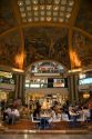 Fresco paintings adorn the ceiling of Galeria Pacifico and cafe seating in Buenos Aires, Argentina.