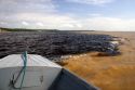 The bow of a boat at the confluence of the Amazon River and the Rio Negro at Manaus, Brazil.