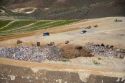Aerial view of trucks and tractors working at the sanitary landfill in Boise, Idaho.