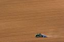 Aerial view of a farmer on a tractor planting seed in Canyon County, Idaho.