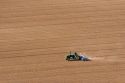Aerial view of a farmer on a tractor planting seed in Canyon County, Idaho.