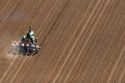 Aerial view of a farmer on a tractor planting seed in Canyon County, Idaho.