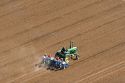 Aerial view of a farmer on a tractor planting seed in Canyon County, Idaho.