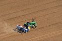 Aerial view of a farmer on a tractor planting seed in Canyon County, Idaho.