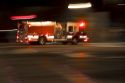 Fire truck in motion at night with lights flashing in Boise, Idaho.