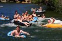 People on inflatable rafts floating the Boise River in Boise, Idaho.