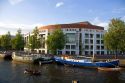 Boating on the Amstel River in front of the Stopera in Amsterdam, Netherlands.