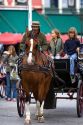 Children ride in a horse drawn carriage in Big Market Square at Bruges in the province of West Flanders, Belgium.