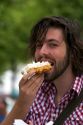 Tourist eating a belgian waffle at Bruges in the province of West Flanders, Belgium.