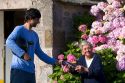 French letter carrier delivering mail to an elderly woman in the commune of Barfleur in the region of Basse-Normandie, France.
