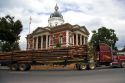 A logging truck passes in front of the historic Meriwether County Courthouse in Greenville, Georgia.