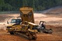 Bulldozer and dump truck being used for road construction in Georgia.
