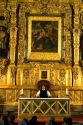 A priest performs mass in front of a gold alter in the Catedral Metropolitana located on the central square, the zocalo, Mexico.