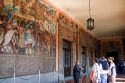 Tour guide showing tourists murals painted by Diego Rivera at the National Palace in Mexico City, Mexico.