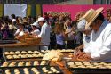 Bread being made into the shape of a skull to be given to a crowd of people celebrating the Day of the Dead in the Zocalo in Mexico City, Mexico.