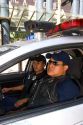 Mexican police officers sit in a police car with a remote camera on the roof which transmits real time images to a command center in Mexico City, Mexico.