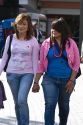 Young Mexican women holding hands at Insurgentes Plaza in Mexico City, Mexico.