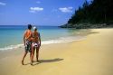 A couple walking on Nai Yang beach on Phuket Island, Thailand.