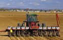 Tractor pulling a seed corn planter.