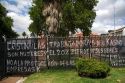 Protest graffiti on a fence in front of the Casa Rosada located on the eastern end of the Plaza de Mayo in Buenos Aires, Argentina.