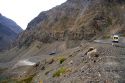 Vehicles drive on switchback roads in the Andes Mountain Range, Chile.
