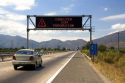 Spanish language road sign reads, Drive With Caution, near Santiago, Chile.