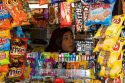 Woman sellling snacks and magazines from a kiosk on the Paseo Ahumada in Santiago, Chile.
