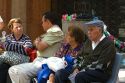 People sit on a bench on the Paseo Ahumada in Santiago, Chile.