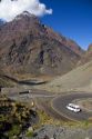 Trucks drive on switchback roads in the Andes Mountain Range in Chile.
