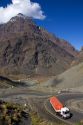 Trucks drive on switchback roads in the Andes Mountain Range in Chile.