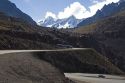 Vehicles drive on switchback roads in the Andes Mountain Range in Chile.