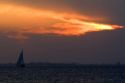Sailboat and sunset at Fort Myers Beach on Estero Island in Lee County, Florida.