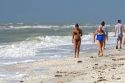 Beachcombers searching for seashells on the beach at Sanibel Island on the Gulf Coast of Florida.