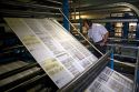 Newspaper being printed on a rotary printing press for the Houston Chronicle in Houston, Texas.