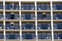 People on balconies of hotel rooms at Galveston Beach in Galveston, Texas.