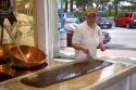 Worker making chocolate fudge at a candy shop in Sault Ste. Marie, Michigan.