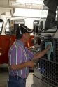Worker cleaning a newly manufactured fire truck chassis at Spartan Motors in Charlotte, Michigan.