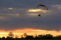 Powered parachute flying at sunset in Eaton County, Michigan.