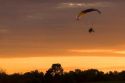 Powered parachute flying at sunset in Eaton County, Michigan.