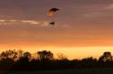 Powered parachute flying at sunset in Eaton County, Michigan.