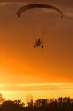 Powered parachute flying at sunset in Eaton County, Michigan.