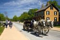 Horse drawn taxi passing by the Sarah Jordan Boarding House in Greenfield Village at The Henry Ford in Dearborn, Michigan.