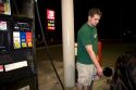 Gas prices displayed behind a man pumping gas in Lansing, Michigan on May 31, 2008.