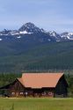 Log barn sits below the Mission Mountains north of Missoula, Montana.