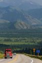 Dump truck traveling over the high mountain Teton Pass on Wyoming Highway 22 near the state border of Wyoming and Idaho.