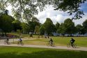 Bicyclists ride along the Seawall path in Stanley Park at Vancouver, British Columbia, Canada.