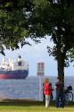 People stand along the Seawall in Stanley Park at Vancouver, British Columbia, Canada.