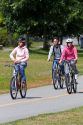 Bicyclists ride along the Seawall path in Stanley Park at Vancouver, British Columbia, Canada.