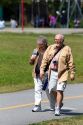 Tourists walk along the Seawall path in Stanley Park at Vancouver, British Columbia, Canada.