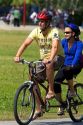 Couple riding a tandem bicycle along the Seawall path in Stanley Park at Vancouver, British Columbia, Canada.